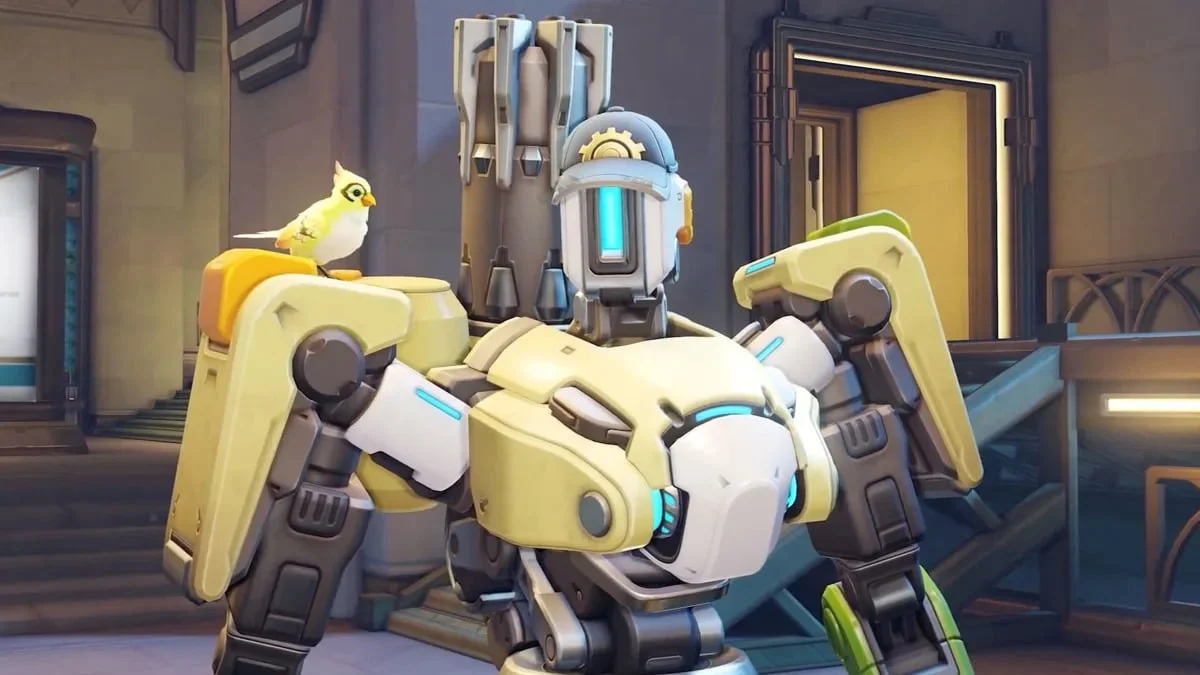 Bastion, a friendly Omnic robot from Overwatch 2, wears a hat while standing in a room.