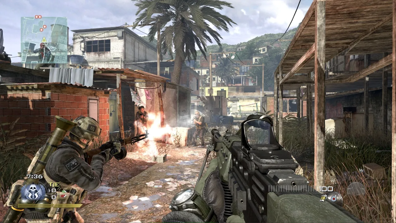 A character fires a weapon alongside an ally down a pathway lined with buildings, with a Brazilian favela and mountain in the background in Call of Duty: Modern Warfare 2 (2009).