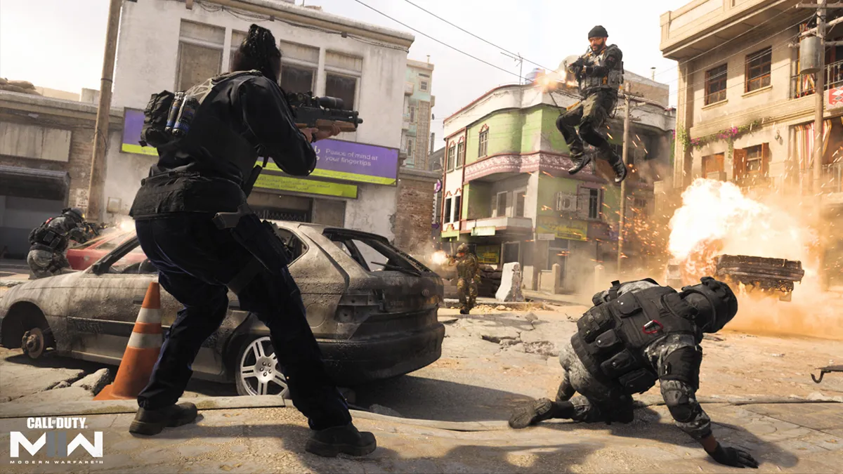 Soldiers in full military gear shoot at an enemy, who is hovering mid-air as an explosion goes off behind them in a city in Call of Duty.